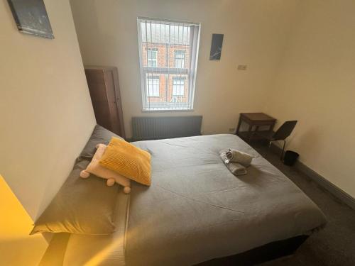 a bedroom with a bed with a stuffed animal on it at Conway Home of Relaxations in Stoke on Trent