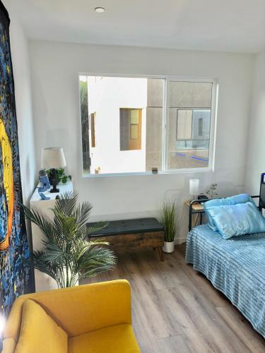 a bedroom with a bed and a window at Luxe Home Near DTLA & Dodgers with Rooftop in Los Angeles