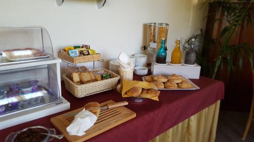 a table with bread and baskets of food on it at Villa Margherita in Cefalù