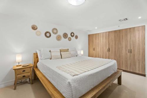 a bedroom with a large bed and a wooden cabinet at Eagle Beach-Best value-Island View 1BR condo-R362 in Palm-Eagle Beach