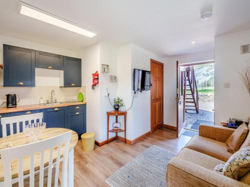 a kitchen and living room with a couch and a table at Ben View in Aberlour