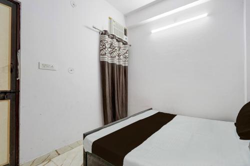 a bedroom with a bed in a room at Hotel O Shri Panchmukhi Residency Baran Road in Kota