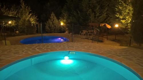 a swimming pool at night with a playground at Tamerici House in Montecastrilli