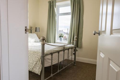 a bedroom with a bed and a window at California Cottage 2 in Middleton in Teesdale