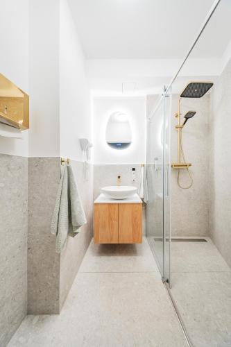 a bathroom with a sink and a shower at District One - Hideaway Hostel in Vienna