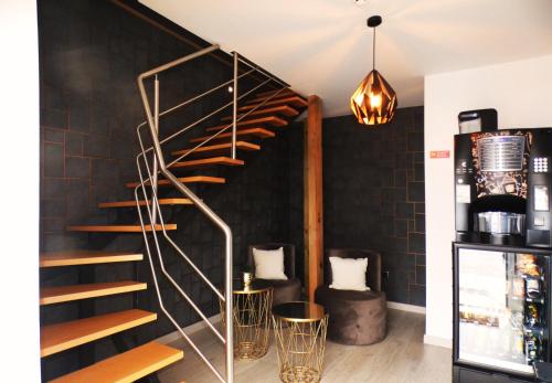 a spiral staircase in a room with black brick walls at Pinhal Litoral in Marinha Grande