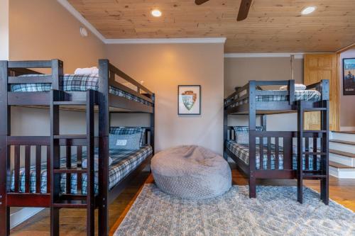 a room with three bunk beds in a house at Blue Ridge Vista in Banner Elk