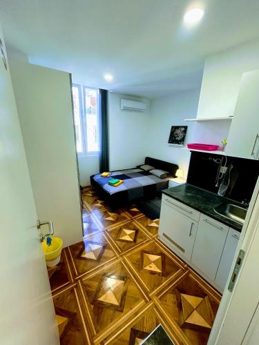 a room with a kitchen and a living room at Pula-Center Studio Apartments in Pula
