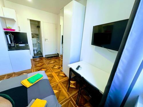a small room with a table and a tv on a wall at Pula-Center Studio Apartments in Pula