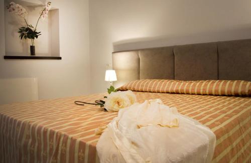 a hotel room with a bed with flowers on it at Il Centenario in Ascea