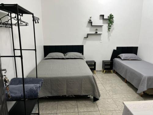 Ένα ή περισσότερα κρεβάτια σε δωμάτιο στο Espaço Ideal 3