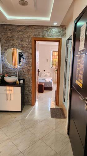 a hallway with a bathroom and a bedroom with a bed at House Viola in Imsouane