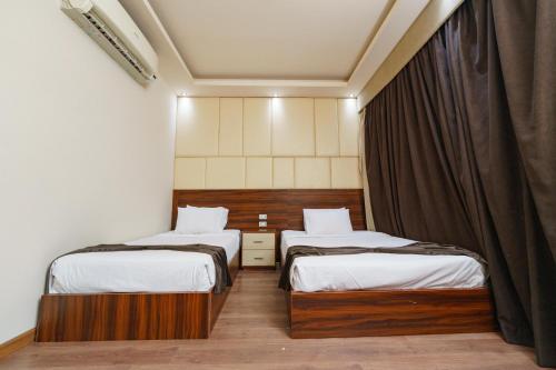 Ένα ή περισσότερα κρεβάτια σε δωμάτιο στο Elite Grand City