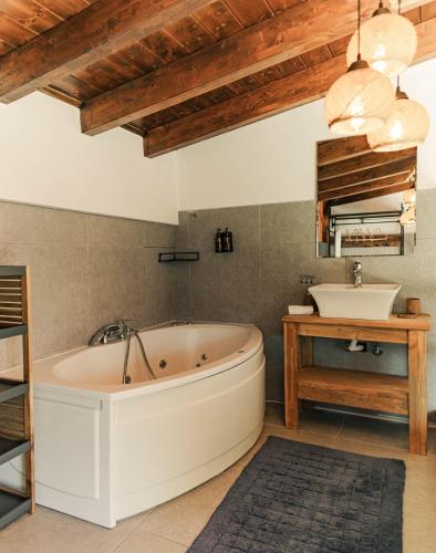 a large bathroom with a tub and a sink at Mont Rock in Synikia Mesi Trikalon