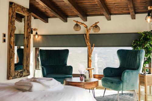 a bedroom with two chairs and a bed and a table at Mont Rock in Synikia Mesi Trikalon