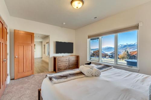 a bedroom with a large bed with a large window at Windriver Hideaway - Private Hot Tub in Wolf Creek Village
