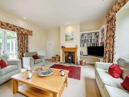 a living room with a table and a fireplace at Doxford House - Uk49888 in Preston