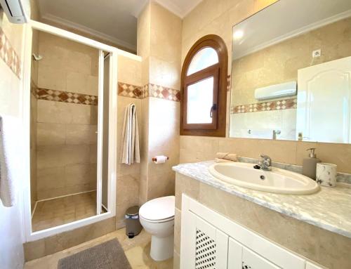 a bathroom with a sink and a toilet and a shower at Casa Kessing in Orihuela Costa