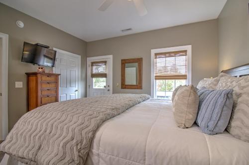 a bedroom with a large bed and a television at Stairway to Havens - North in Myrtle Beach