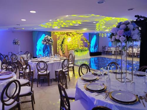 a banquet hall with white tables and chairs and flowers at Eurohotel in Ciudad del Carmen