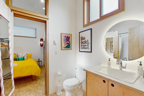 a bathroom with a sink and a toilet and a mirror at The HUB in Eugene