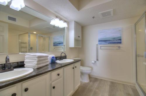 a bathroom with two sinks and a toilet and a shower at Crescent Shores South - 511 in Myrtle Beach