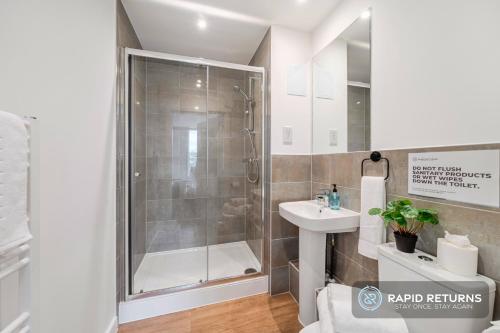 a bathroom with a shower and a sink at BRAND NEW! Modern & Spacious Serviced Apartments With FREE Parking & Gym by Rapid Returns - Professional Host in Walton-on-Thames