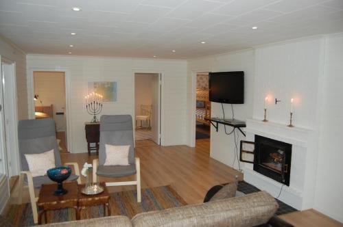 a living room with a couch and a fireplace at Holiday Home Sjöhagen in Noby