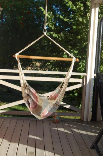 a hammock is hanging on a porch at Holiday Home Sjöhagen in Noby