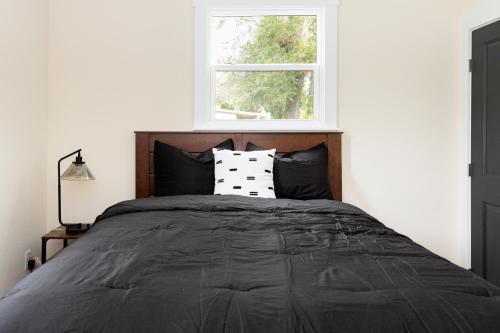 a bedroom with a large bed with a window at Free parking, Free WiFi 2 bed home in Tampa