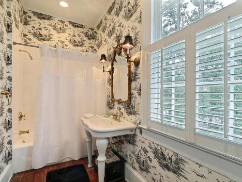 a bathroom with a sink and a window at Mint Julep Estate in Savannah