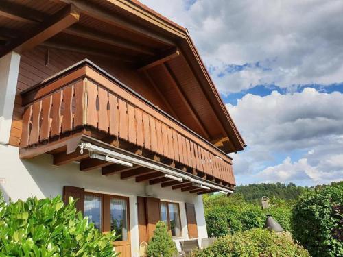 a house with a wooden balcony on top of it at Chalet Traumfleck in Necker