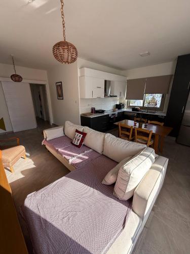 a living room with a white couch and a kitchen at Central Nicosia Haven in Nicosia