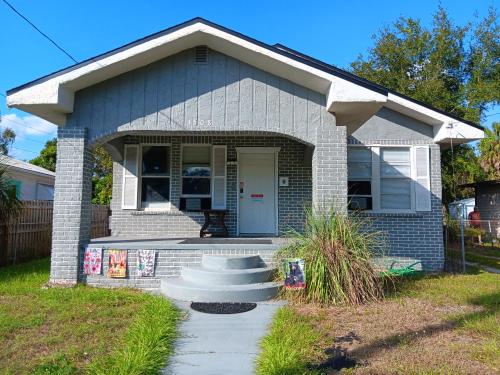 a small house with a front porch and stairs at Hostel Tampa near downtown, 15 minutes to airport, self check-in, NO BREAKFAST in Tampa