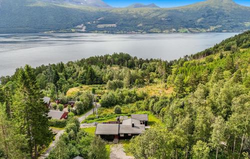 an aerial view of a house on a hill next to a lake at Cozy Home In Meisingset With Kitchen in Meisingset