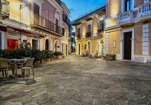 an empty street in a town with tables and chairs at Casa Marina in San Nicola Arcella