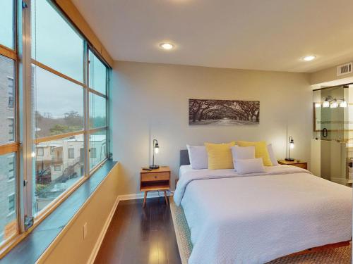 a bedroom with a large bed and a large window at Drayton Escape in Savannah