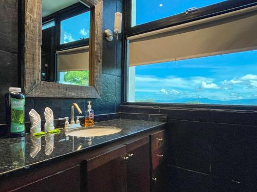 a bathroom with a sink and a window at Casa Cielo Luxury Jungle Retreat, Manuel Antonio in Quepos