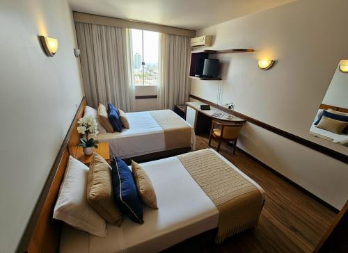 Ένα ή περισσότερα κρεβάτια σε δωμάτιο στο Hotel Santoni