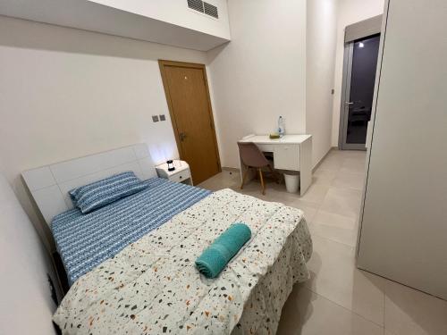 a bedroom with a bed with a blue pillow on it at Cozy Room In Abu Dhabi Reem island Near to Galeria Mall in Abu Dhabi