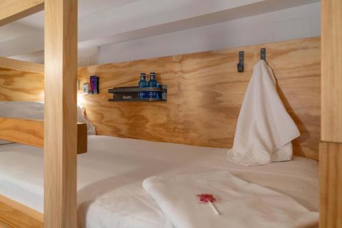 a bed with a towel hanging on a wall at The Hat Madrid in Madrid