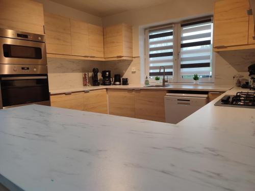 a kitchen with a large white marble counter top at Durbuy Chalet 9p jacuzzi billard jeux in Durbuy
