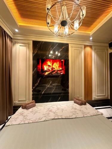 a bedroom with a bed in front of a fireplace at BOULEVARD NEST RESlDENCE in Tashkent