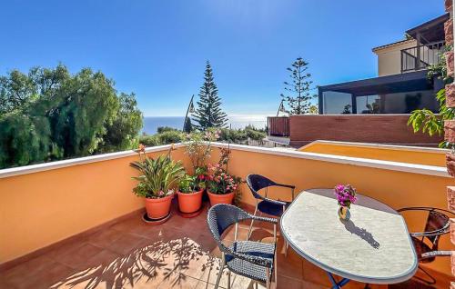 a patio with a table and chairs on a balcony at Lovely Home In Almuñecar With Ethernet Internet in Almuñécar