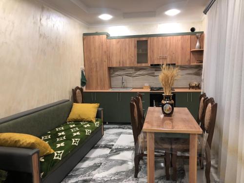 a living room with a couch and a table at Baleni Guesthouse Agritourism in Gyulagarak