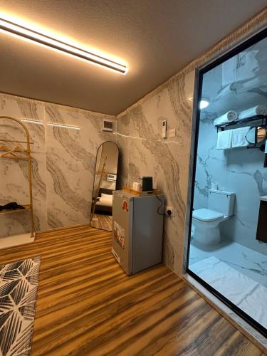 a room with a small refrigerator in a room at The Out Resort in Sinādil