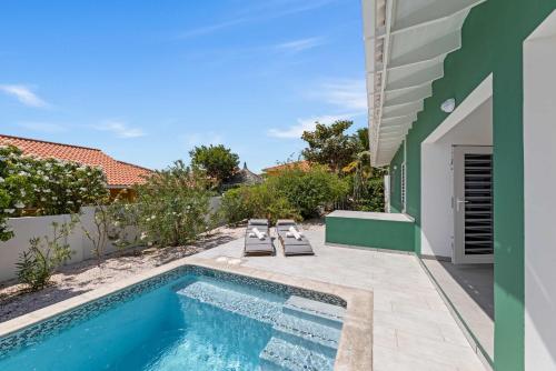 a swimming pool in the backyard of a house at Fuente Verde in Fontein