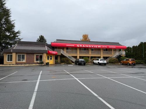 a car dealership with cars parked in a parking lot at Grantview Inn in Surrey