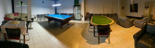 a room with a ping pong table and chairs at BE Happy Event Lounge in Mandaue City