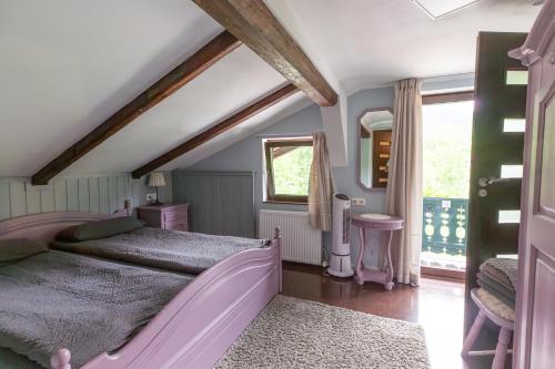 a bedroom with a pink bed and a window at Bergbach in Ramsau